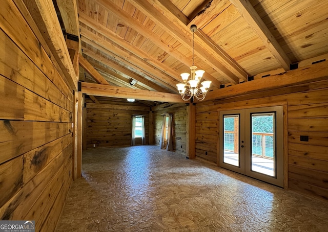 spare room with vaulted ceiling with beams, french doors, wood walls, and wooden ceiling