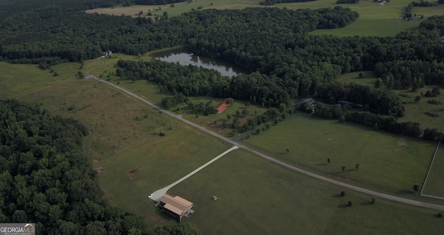 aerial view with a water view, a wooded view, and a rural view