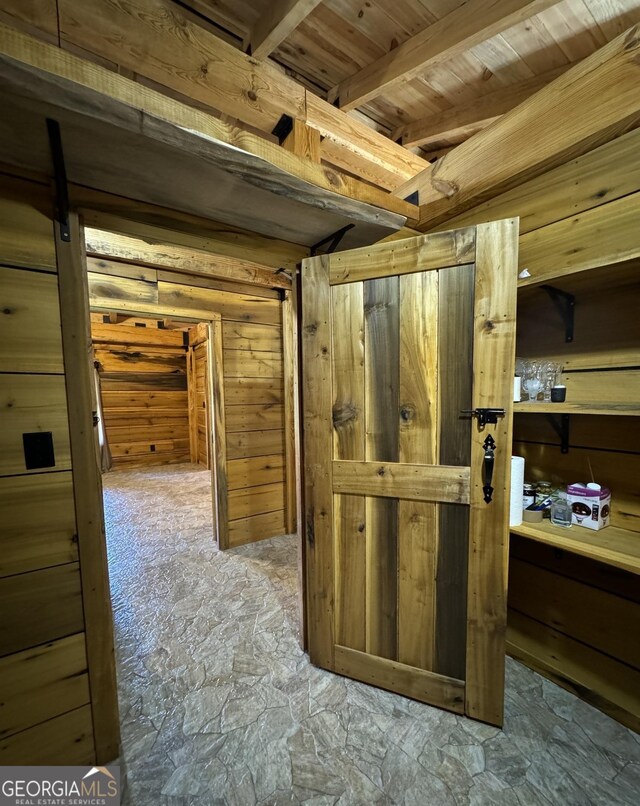 kitchen featuring refrigerator, wooden walls, and independent washer and dryer