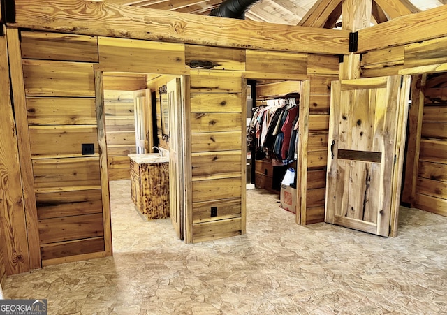 interior space featuring a closet and wood walls