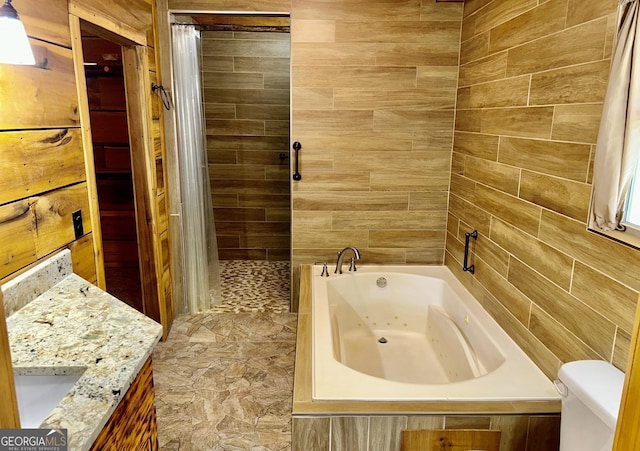 bathroom with tiled shower, toilet, vanity, and a tub with jets