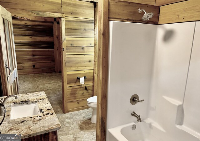 bathroom featuring vanity and wooden walls