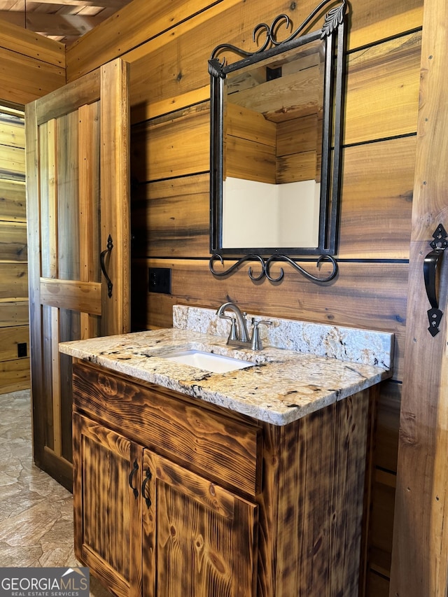 bathroom with wooden walls and vanity