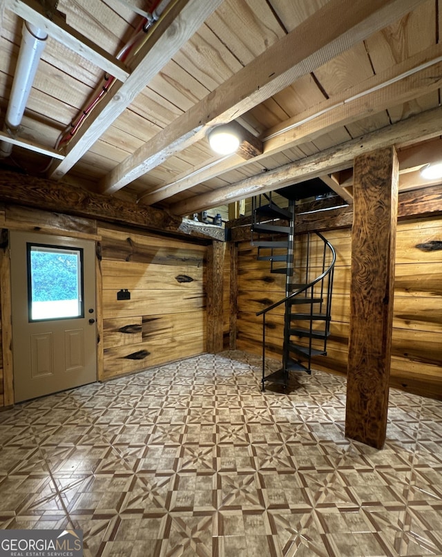 interior space featuring wooden walls, wood ceiling, stairway, tile patterned floors, and beam ceiling