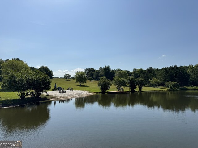 dock area with a water view and a wooded view