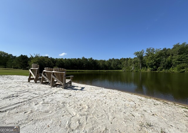 dock area with a water view and a wooded view