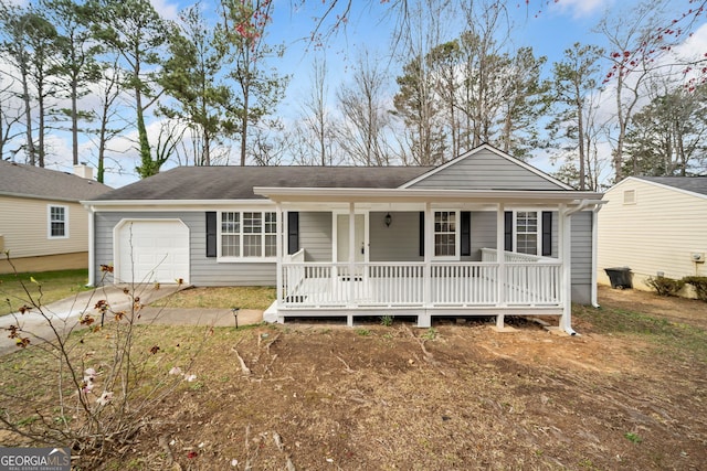 ranch-style home featuring a porch, concrete driveway, and a garage