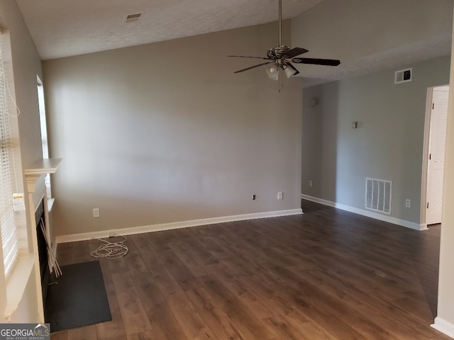 unfurnished living room featuring visible vents, baseboards, dark wood-type flooring, and ceiling fan