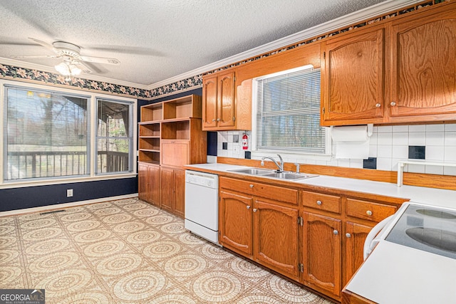 kitchen featuring white dishwasher, brown cabinets, a sink, and light countertops