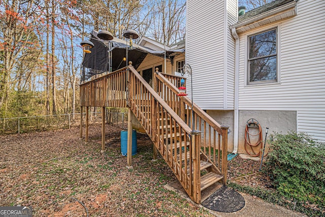 exterior space with stairs, fence, and a deck