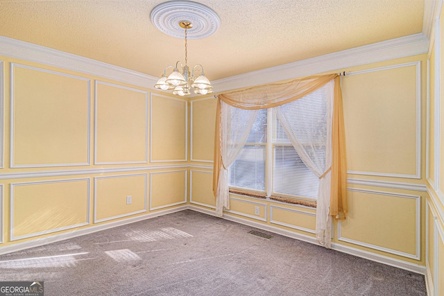 unfurnished dining area featuring visible vents, a textured ceiling, carpet floors, a decorative wall, and a notable chandelier