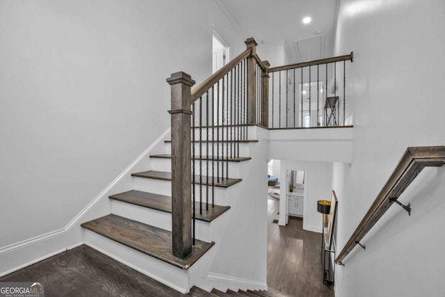2850 Stonehall Ct SE, Smyrna, GA 30339 - staircase with baseboards, a high ceiling, and wood finished floors