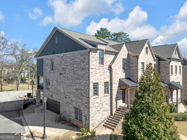 view of property exterior featuring a patio area and brick siding