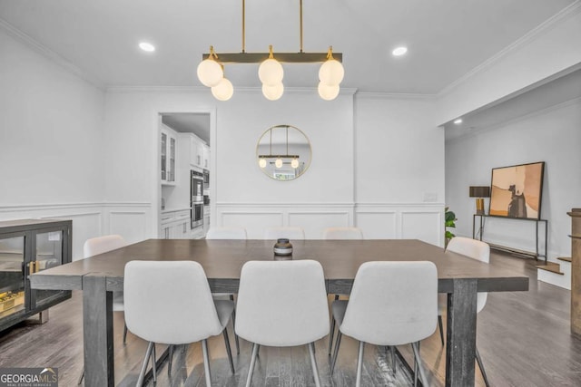 2850 Stonehall Ct SE, Smyrna, GA 30339 - dining room featuring crown molding, dark wood-style flooring, recessed lighting, and a decorative wall