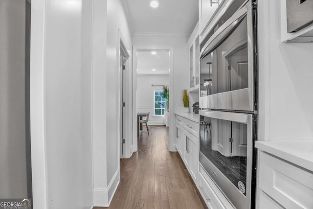 2850 Stonehall Ct SE, Smyrna, GA 30339 - corridor featuring ornamental molding, dark wood-style flooring, and recessed lighting