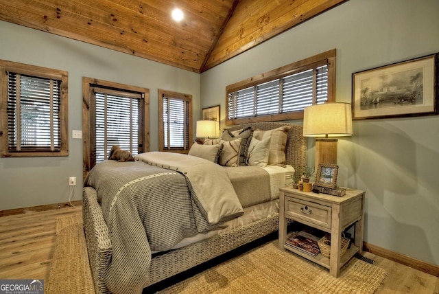 bedroom featuring lofted ceiling, baseboards, wood ceiling, and light wood-style floors