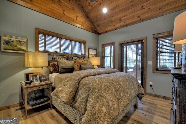 bedroom featuring light wood finished floors, wood ceiling, baseboards, and vaulted ceiling