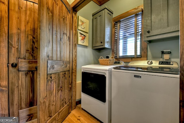 clothes washing area featuring cabinet space, independent washer and dryer, and light wood finished floors