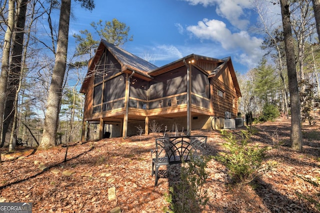 back of house with a sunroom, central AC, and crawl space