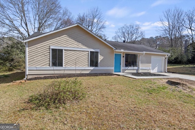 single story home featuring a garage, concrete driveway, and a front yard