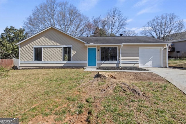 single story home featuring a front lawn, fence, driveway, and an attached garage