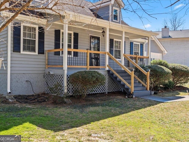 exterior space featuring a porch, a shingled roof, and a front lawn