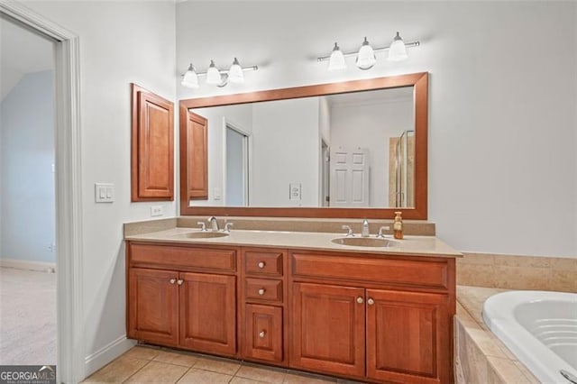 bathroom with a relaxing tiled tub, tile patterned flooring, a sink, and double vanity