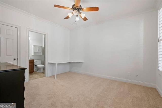 unfurnished bedroom with light carpet, ensuite bath, baseboards, and ornamental molding