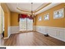 4335 Lakeside Blvd, Monroe, GA 30655 - unfurnished dining area featuring wainscoting, wood finished floors, and a tray ceiling