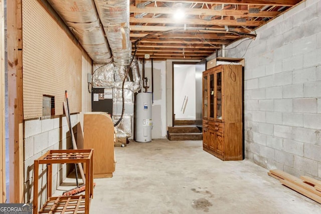 unfinished below grade area with concrete block wall, heating unit, and electric water heater