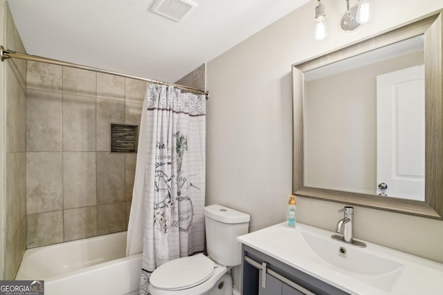 bathroom featuring toilet, vanity, visible vents, and shower / tub combo with curtain