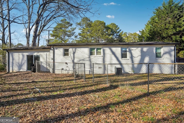 view of home's exterior featuring central AC, brick siding, and fence