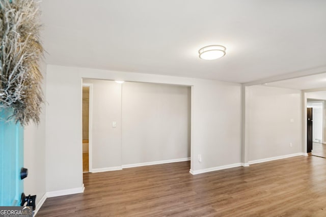 below grade area with baseboards and wood finished floors