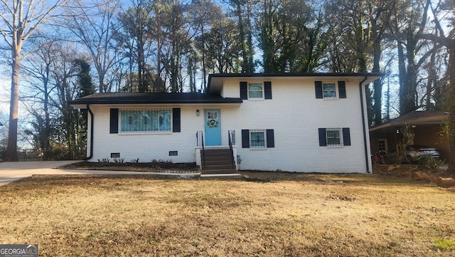 split level home featuring crawl space, brick siding, and a front lawn