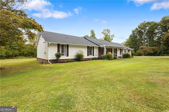 ranch-style home featuring a porch and a front yard