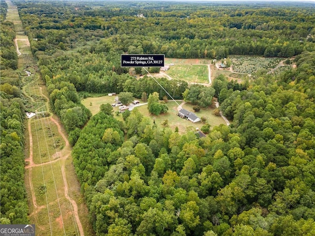 aerial view featuring a wooded view