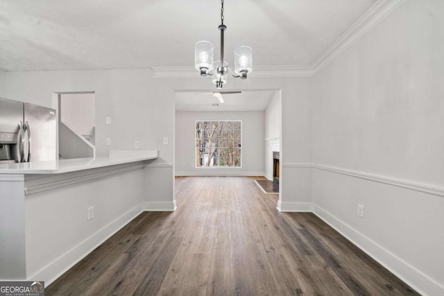 2111 Glenwood Downs Dr, Decatur, GA 30035 - unfurnished dining area with a chandelier, dark wood finished floors, a fireplace with flush hearth, and crown molding