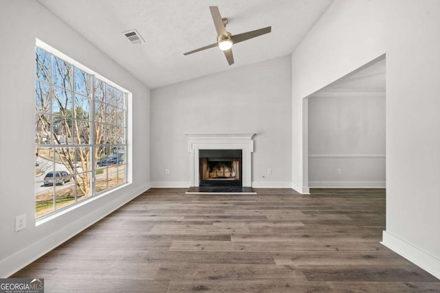2111 Glenwood Downs Dr, Decatur, GA 30035 - unfurnished living room with plenty of natural light, ceiling fan, a fireplace with raised hearth, wood finished floors, and lofted ceiling