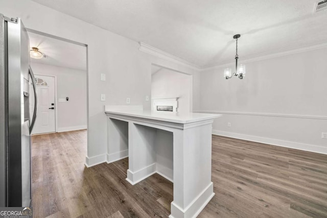 2111 Glenwood Downs Dr, Decatur, GA 30035 - kitchen featuring stainless steel fridge with ice dispenser, dark wood-style flooring, ornamental molding, decorative light fixtures, and light countertops
