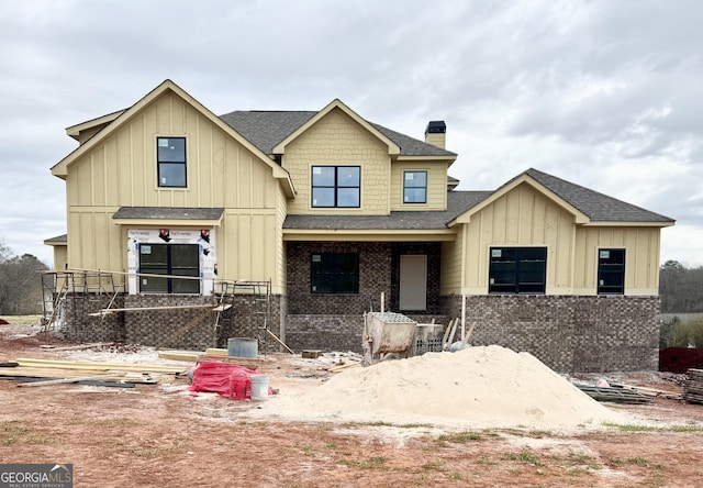 view of front of home with board and batten siding and brick siding