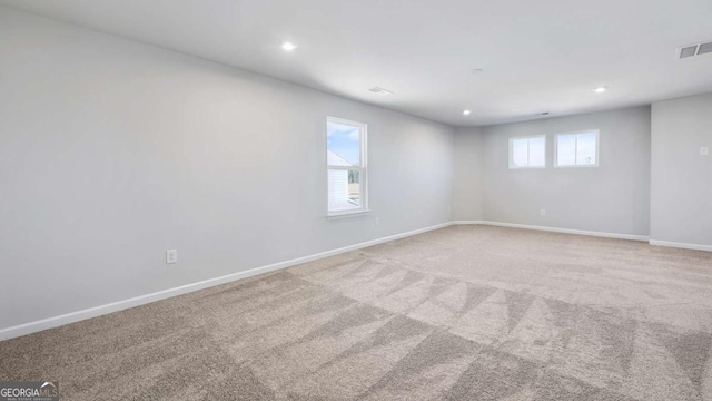 carpeted empty room with recessed lighting, visible vents, and baseboards