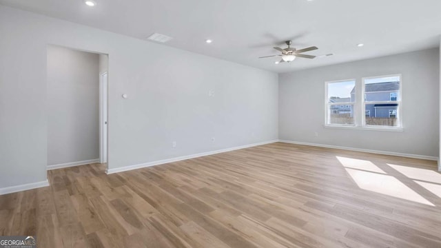 empty room with baseboards, recessed lighting, a ceiling fan, and light wood-style floors