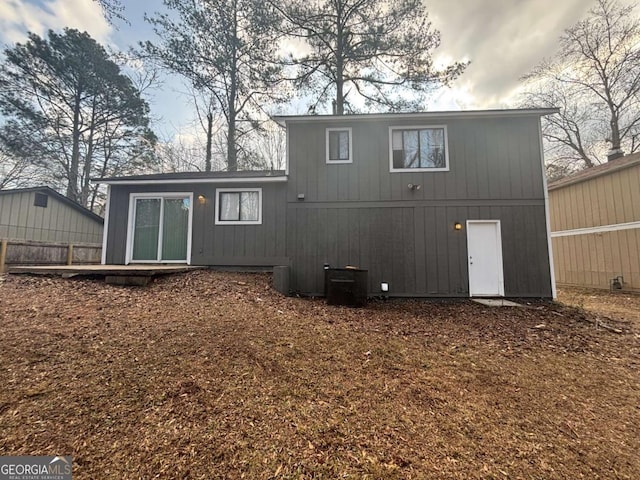 rear view of property featuring central AC