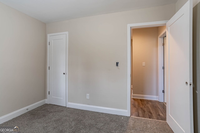 unfurnished bedroom featuring baseboards and carpet floors