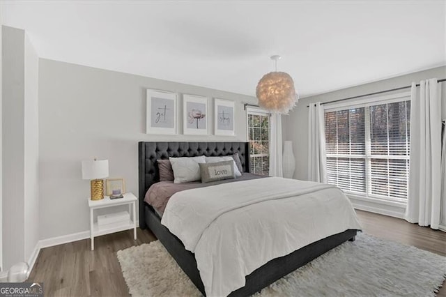 bedroom featuring baseboards and wood finished floors