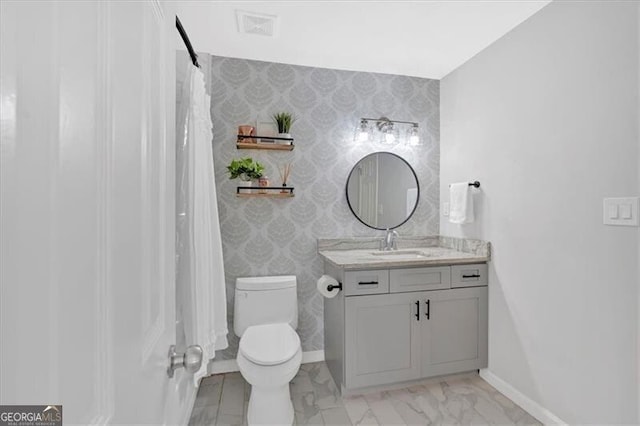 full bath with baseboards, vanity, toilet, and wallpapered walls