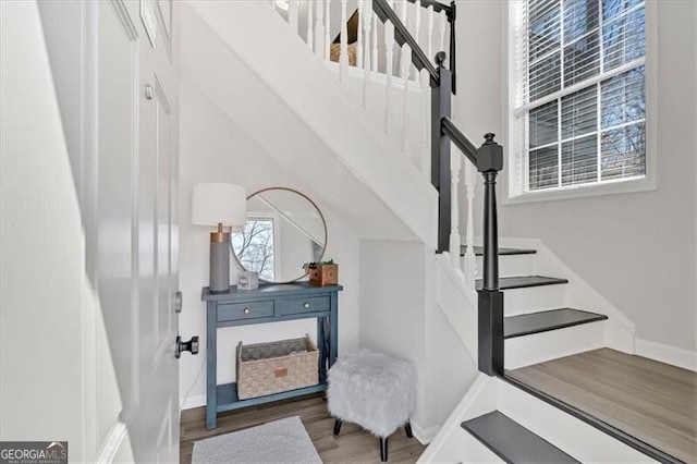 stairway with baseboards and wood finished floors