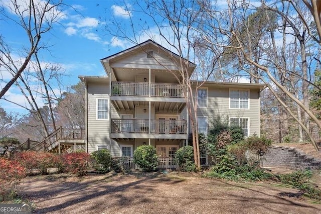 back of property with a balcony