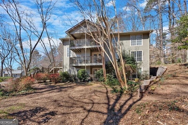 back of property featuring a balcony