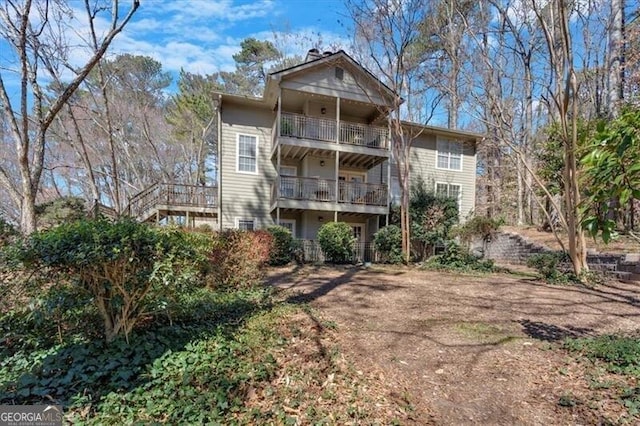 rear view of property featuring a balcony